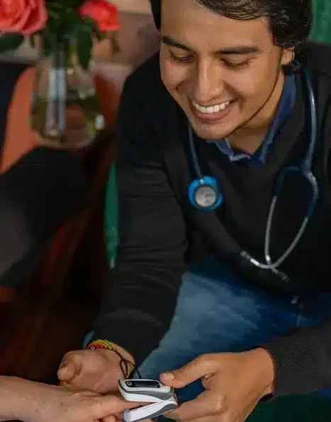 Kevin the doctor at Harmonica Retreat smiling as he's seeing to a patient