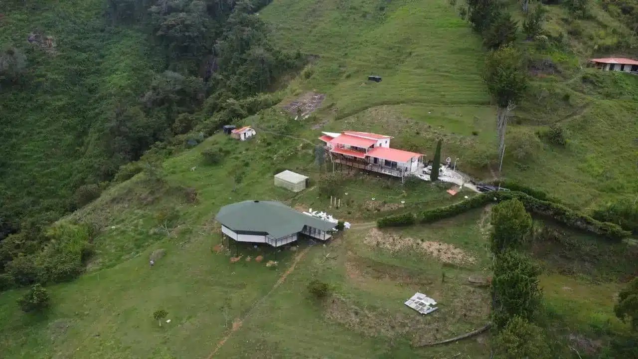 Aerial view of the harmonica retreat site on a mountain in medellin, colombia with the Maloka and main house
