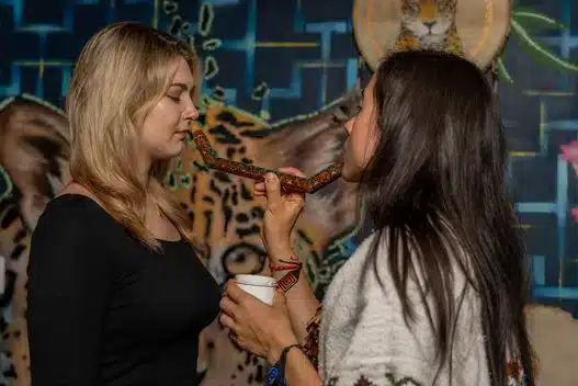 Lead Shaman Vanessa applying Hapey to a patient at Harmonica Retreat