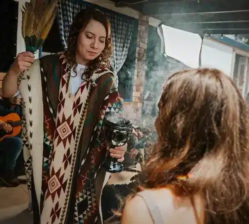 Facilitator applying Sahumerio Incense smoke at Harmonica Retreat