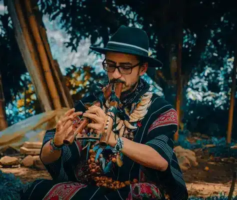 Shaman playing the flute in the nature Harmonica Retreat