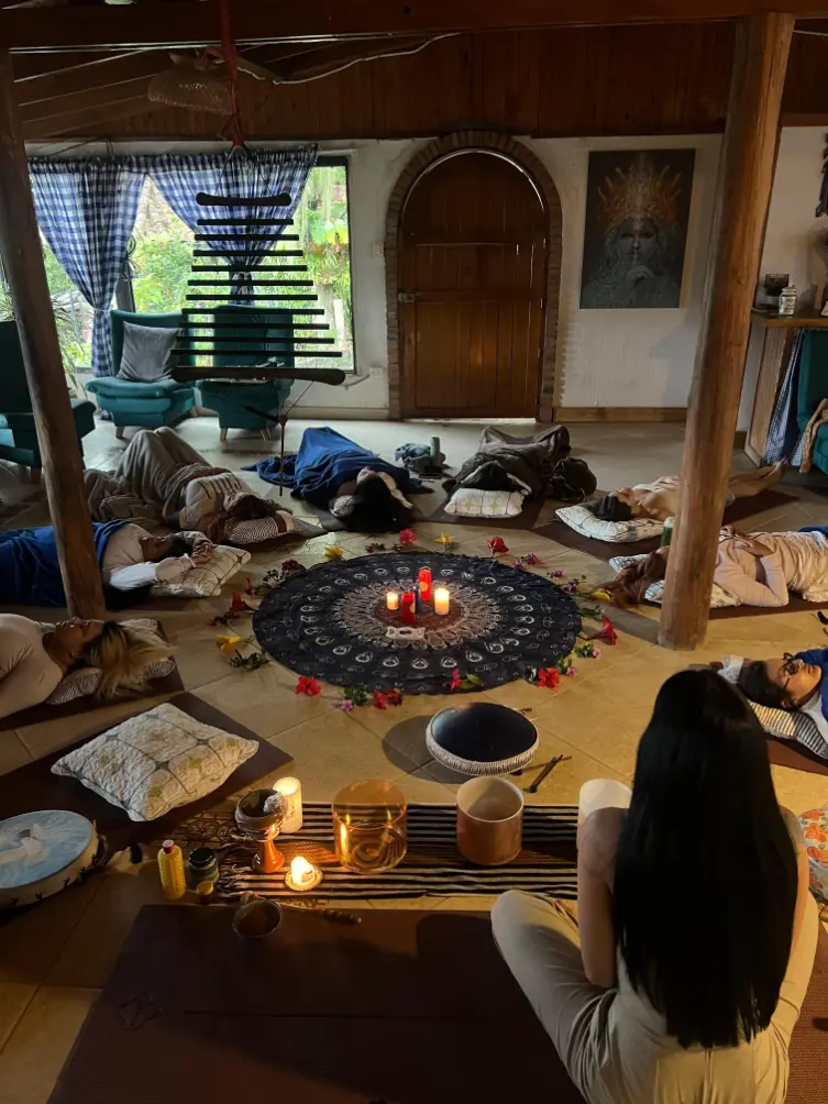 Participants resting in a circle during a cacao ceremony in Medellin