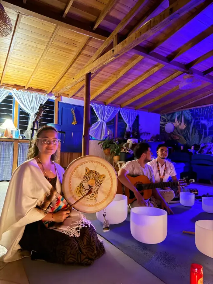 A woman with a painted drum and crystal singing bowls