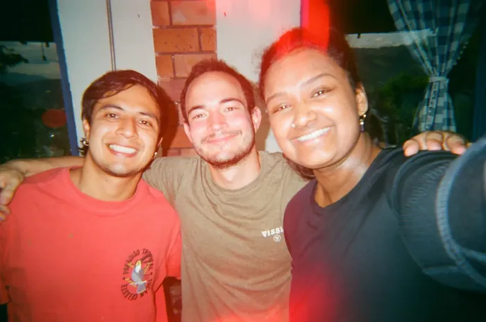 Three friends smiling together in a selfie