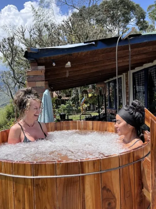 Two participants in a wooden ice bath tub