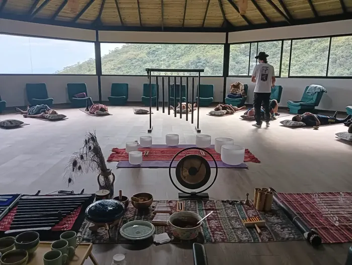 The maloka set up for sound healing with mats, a gong and crystal bowls
