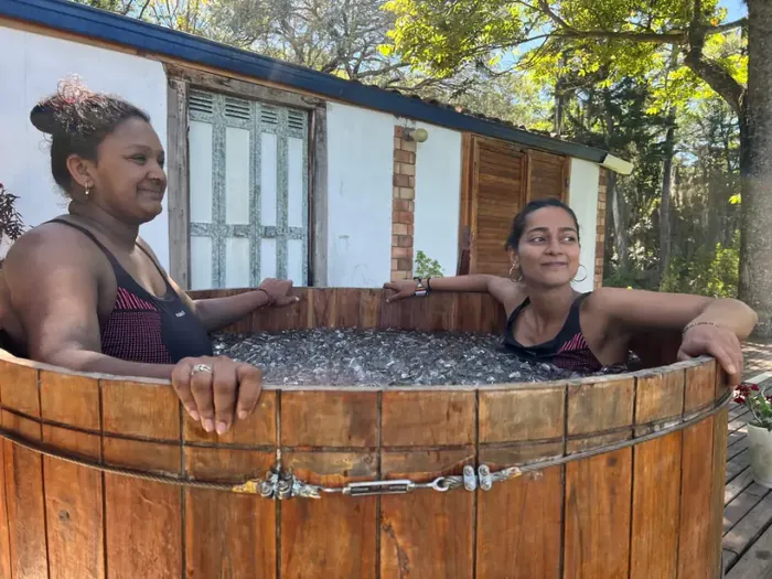 Two women relaxing in the wooden ice bath