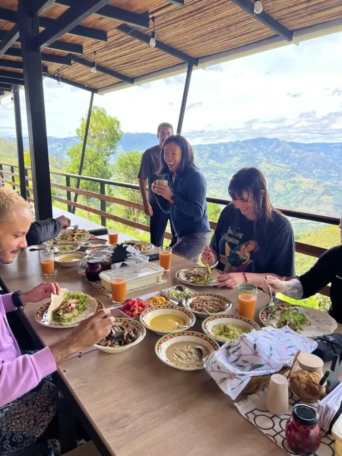 Participants sharing a meal at a table on the terrace