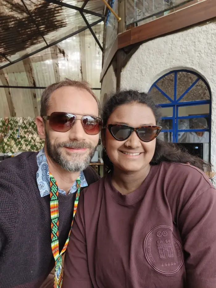 Two friends in sunglasses smiling for a selfie at the house
