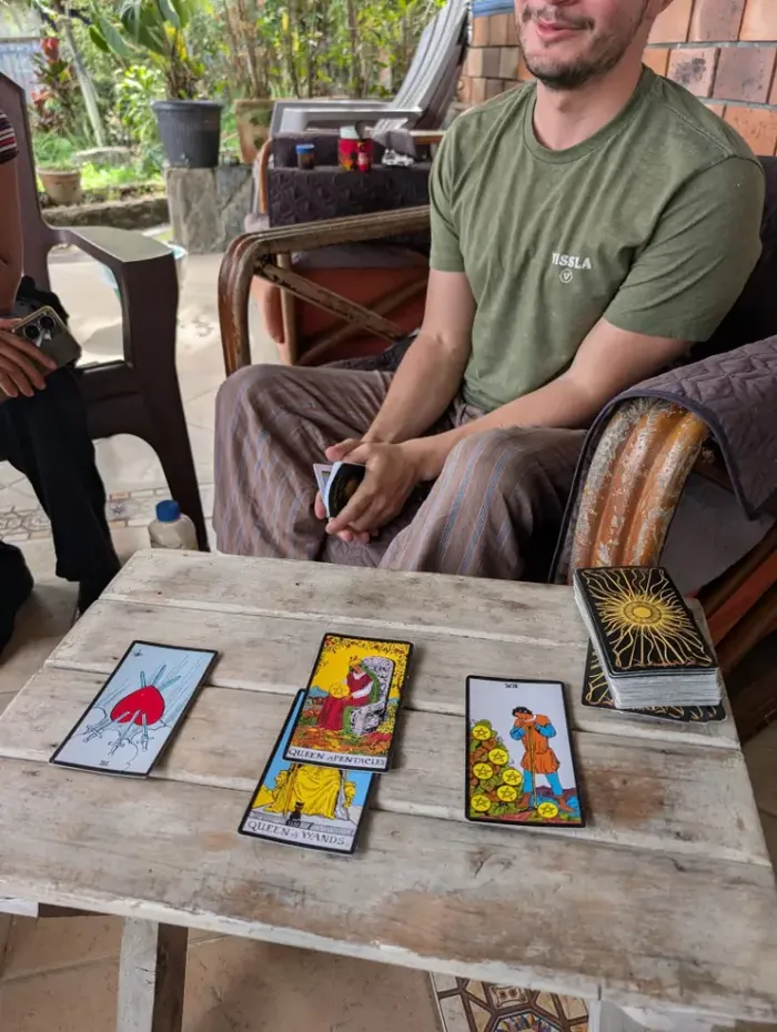 Tarot cards laid out on a wooden table during a reading
